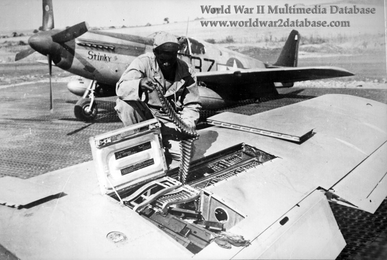 PFC John T. Fields Checks Ammunition on P-51B Mustang of 100th Fighter Squadron