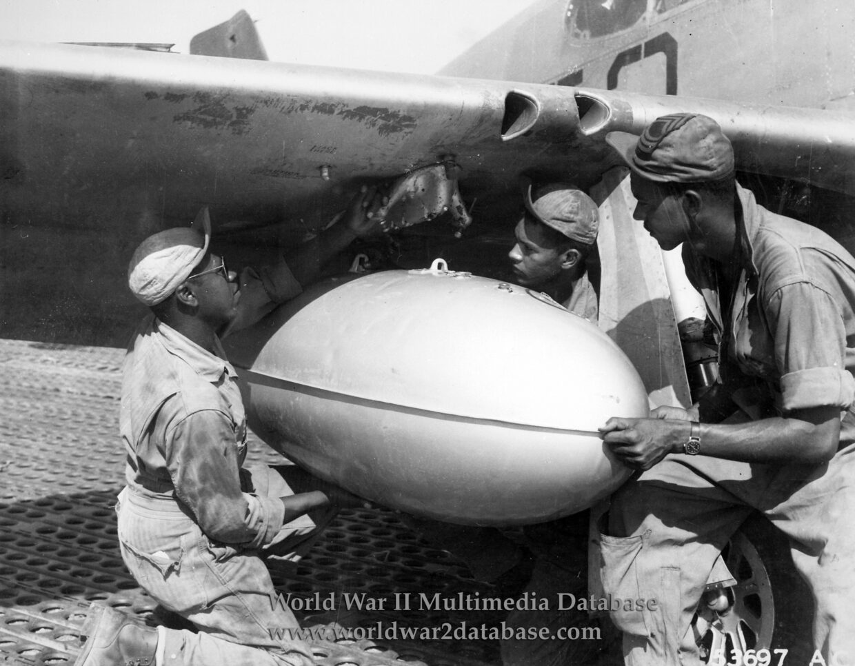 Ground Crew of 301st Fighter Squadron Affix Fuel Tank to P-51C Mustang