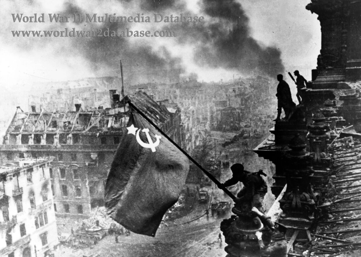 Soldier Raising The Soviet Flag Over The Reichstag