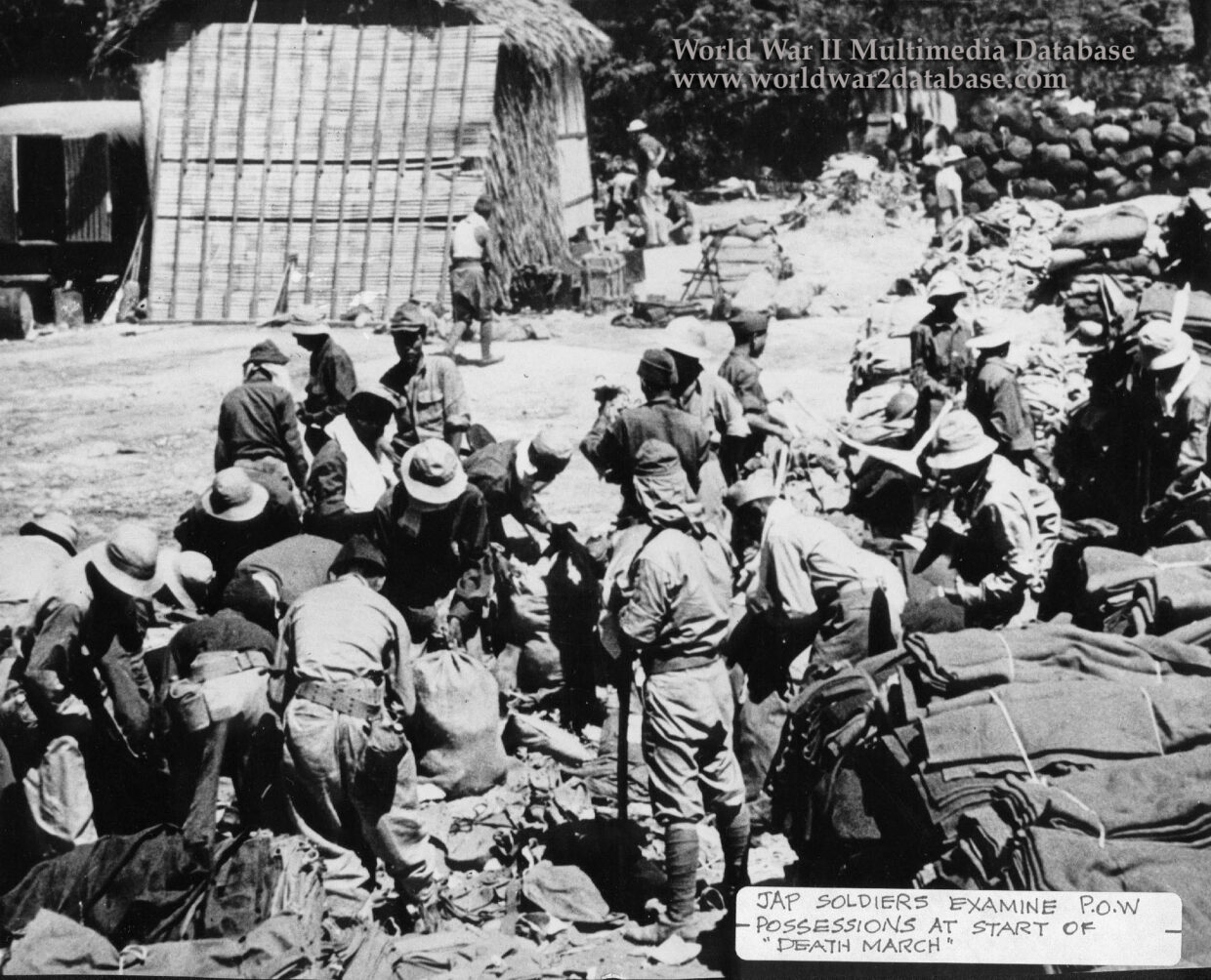 Allied Prisoners of War Sort Confiscated Equipment on Bataan